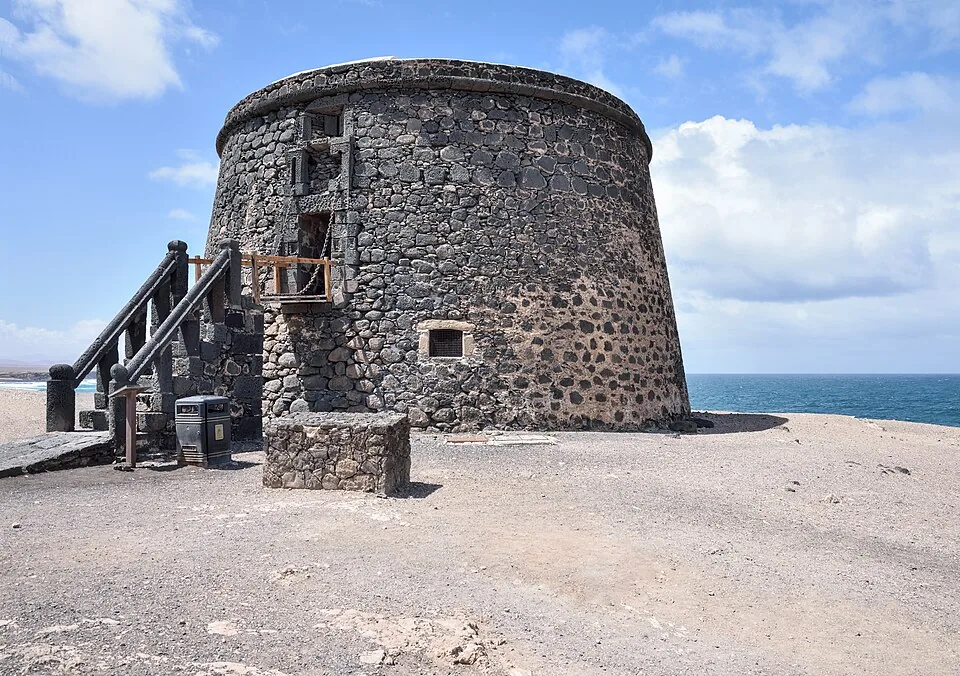 The round stone tower of the Castillo de El Tostón standing above El Cotillo's old harbour on Fuerteventura's north-west coast