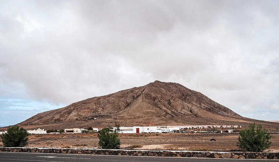 The isolated pale dome of Montaña de Tindaya rising above the flat plain in northern Fuerteventura