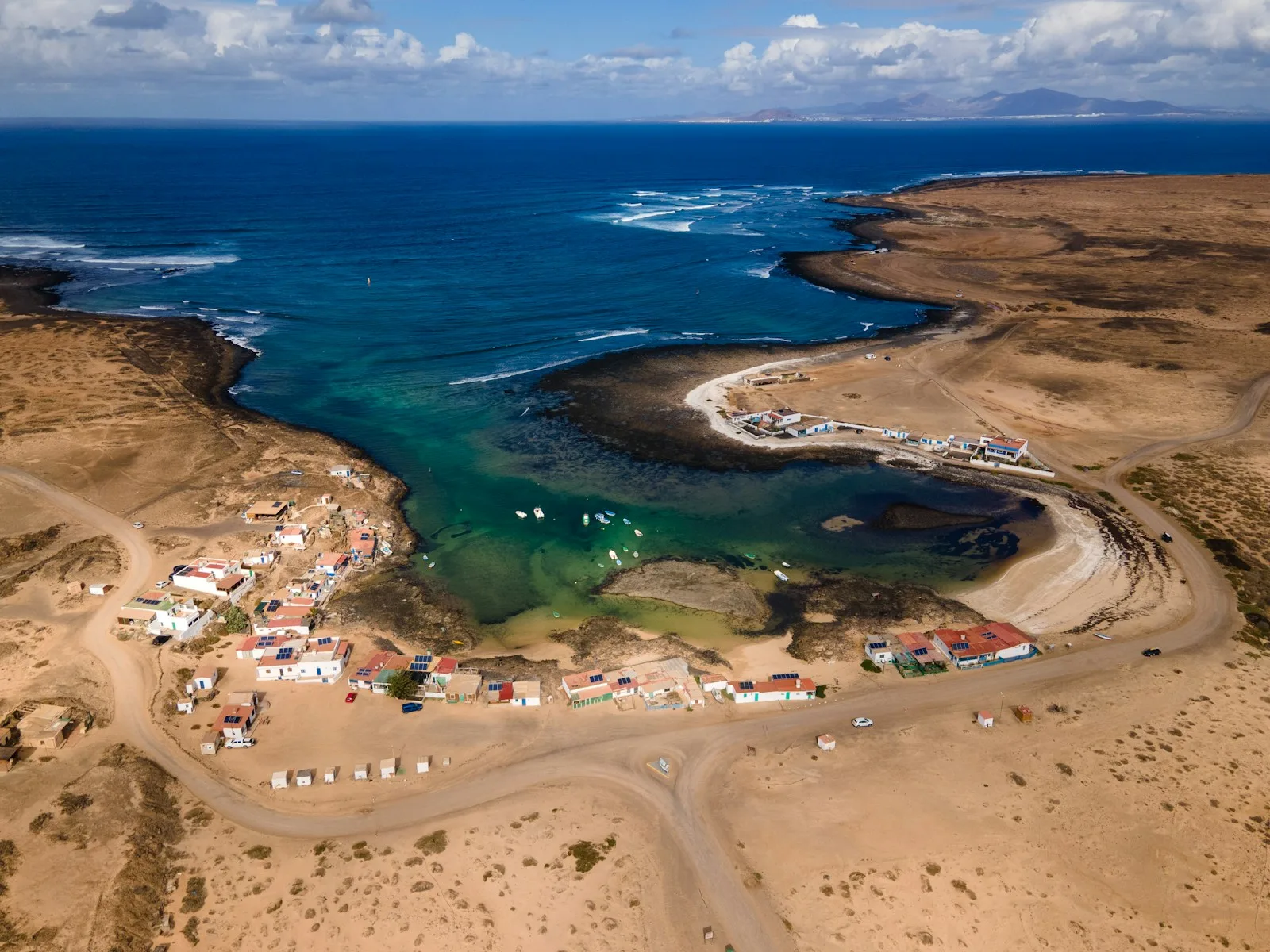 Aerial view of Corralejo town and the white sand dunes of Parque Natural de Corralejo with the Atlantic in the background